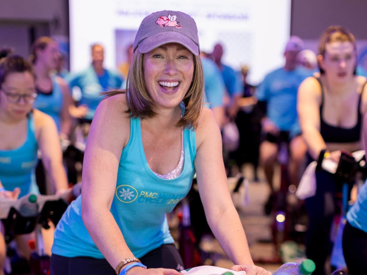 Female PMC Winter Cycle rider on a bike at Fenway Park